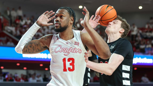 Feb 27, 2024; Houston, Texas, USA; Houston Cougars forward J'Wan Roberts (13) misses a pas and the ball hits Cincinnati Bearcats forward Viktor Lakhin (30) during the second half at Fertitta Center. Mandatory Credit: Troy Taormina-USA TODAY Sports